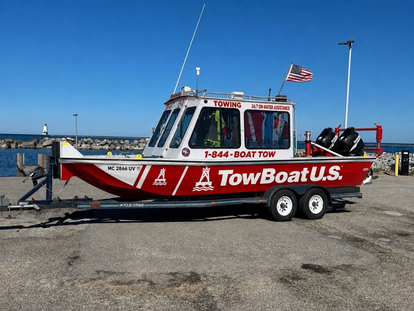 TowBoatUS Sam Rayburn's red and white towing vessel docked at the marina with the company name and (409) 332-5844 number on the hull.